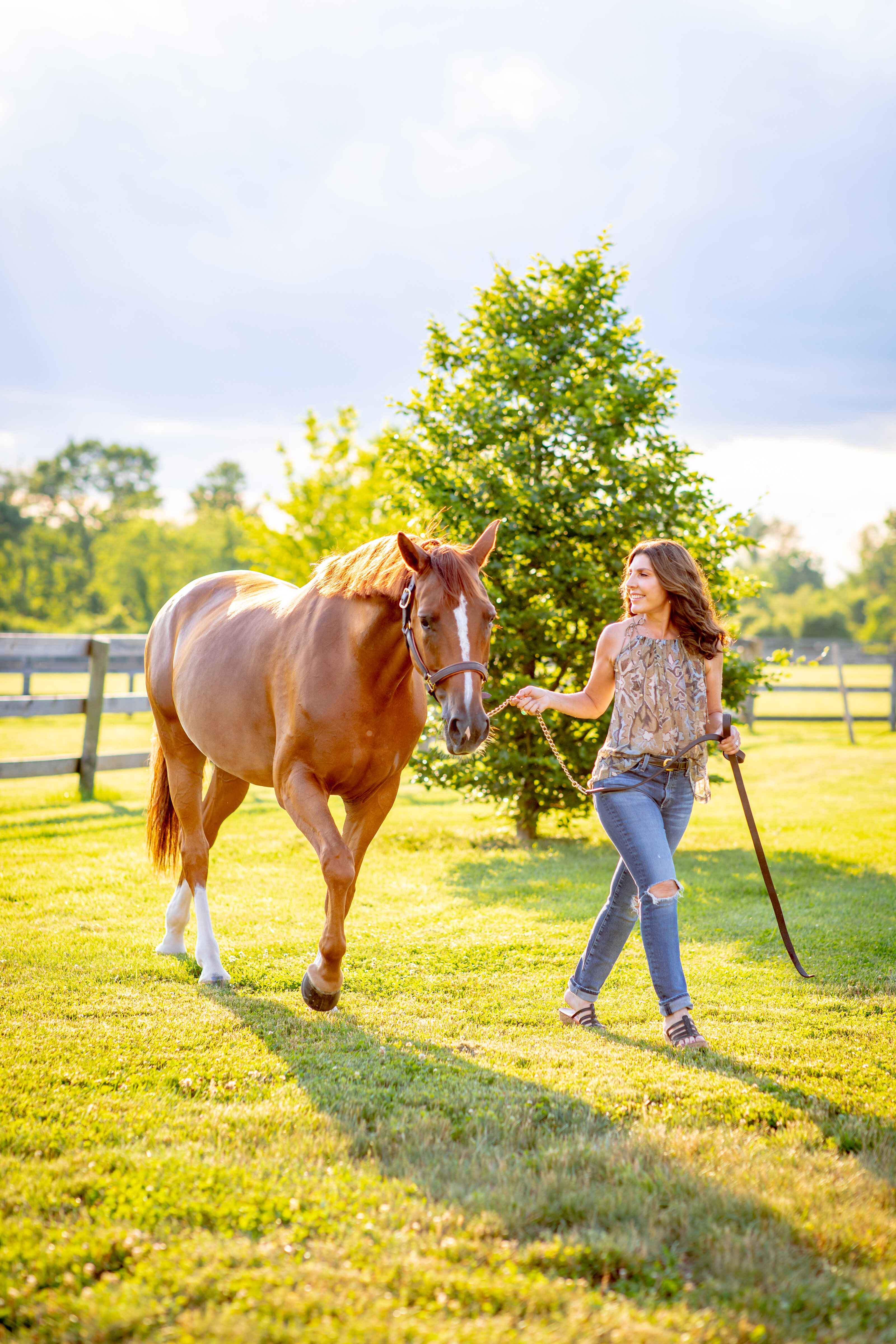 Equestrian senior portrait with horse in open pasture