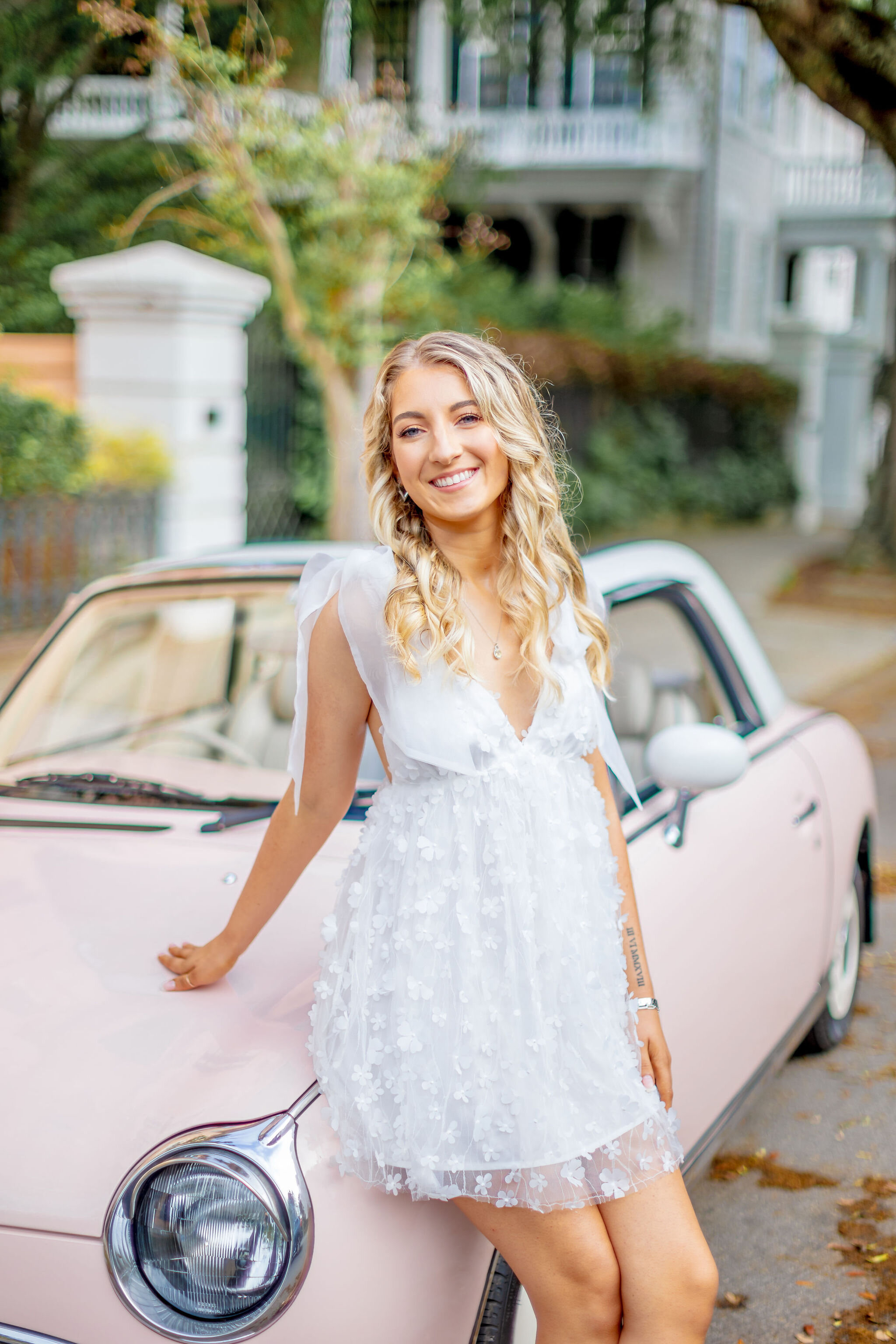 University of Tampa graduation portrait in cap and gown with campus backdrop